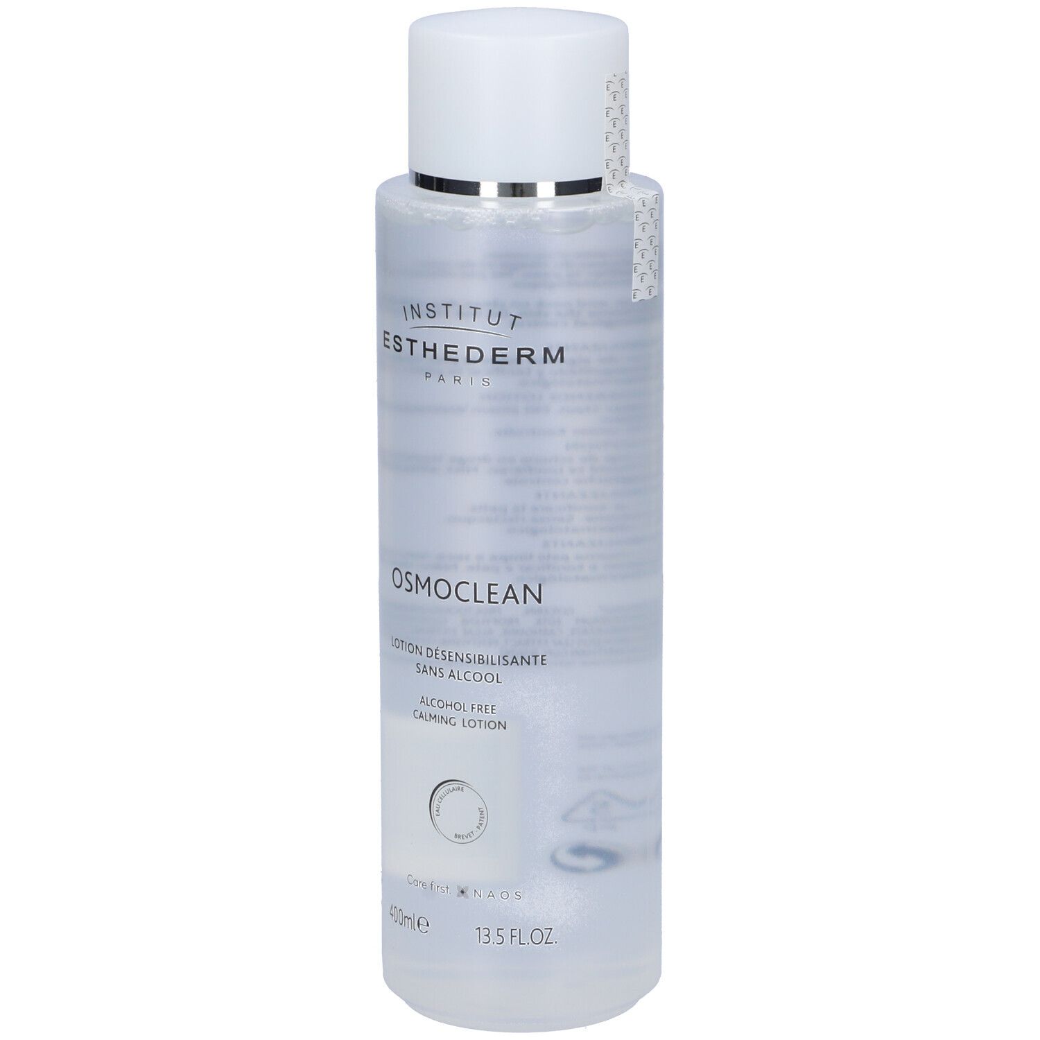 Flacone trasparente con tappo bianco. Scritte: Institut Esthederm, Osmoclean, Lotion Desensibilisante, sans alcool. 400ml, 13.5 FL OZ. Con adesivo.