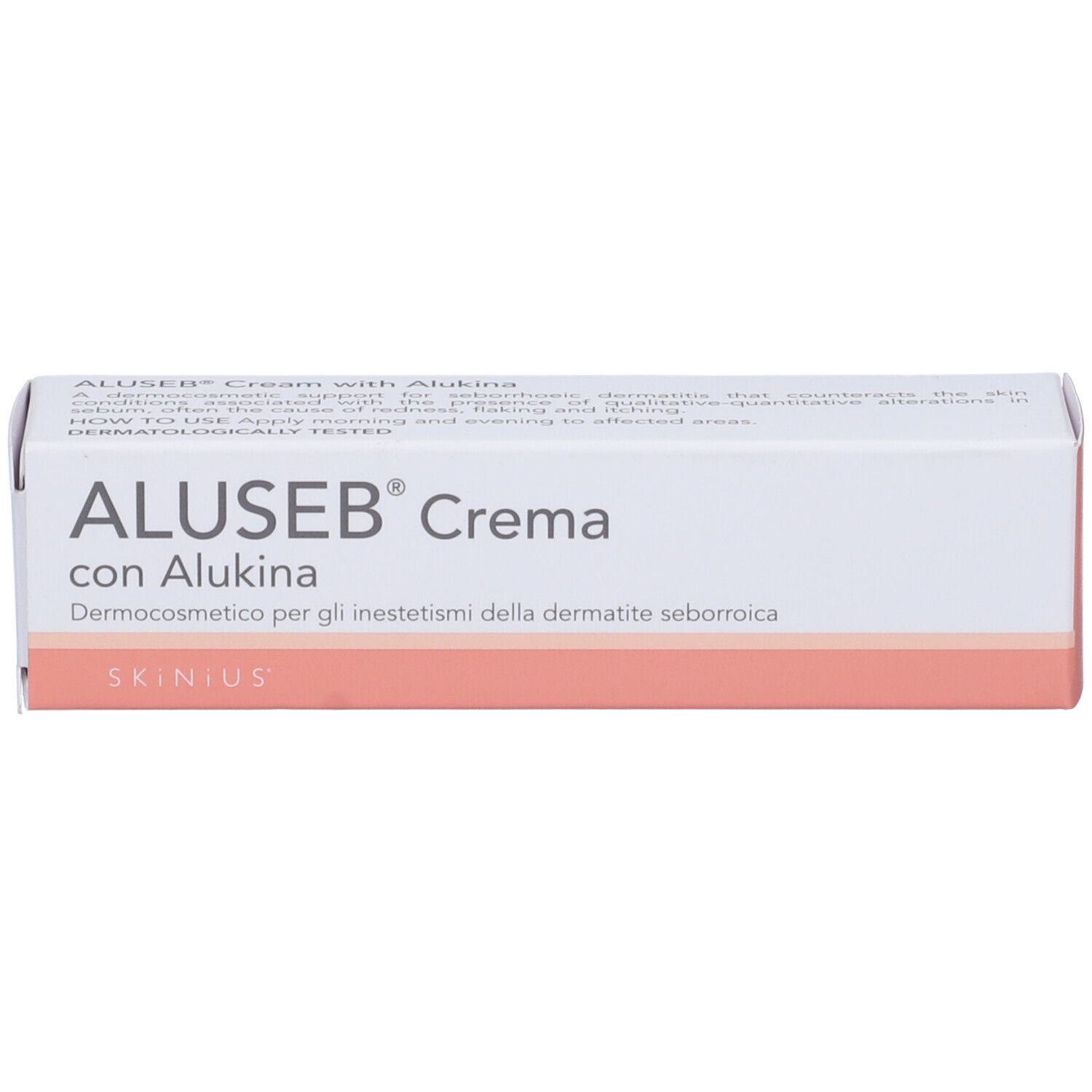 Boîte. Inscription: ALUSEB® Crema con Alukina. Blanc avec accents roses. Dermocosmétique.