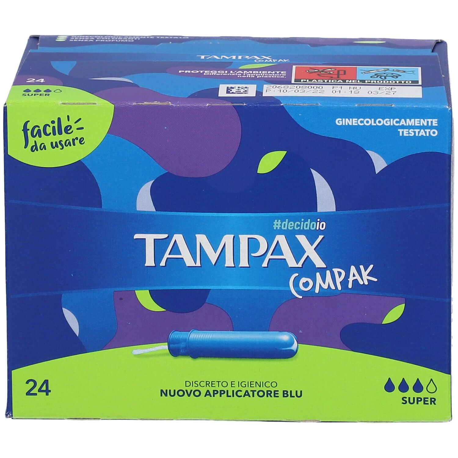 Tampax Compak Super-Verpackung. Blaue Schachtel mit 24 Stück. Aufschrift: Tampax Compak, Super. Grüner und blauer Hintergrund.