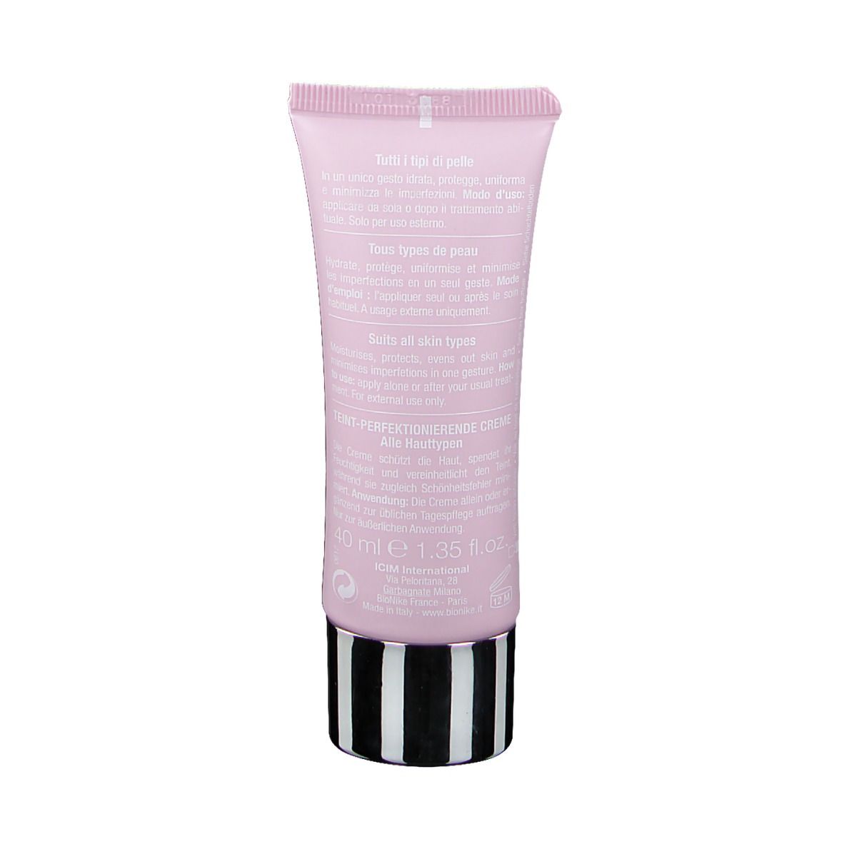 Dos d'un tube rose. Texte en plusieurs langues. Contient des informations sur la crème et ses propriétés. Rayures noires et blanches à la base.