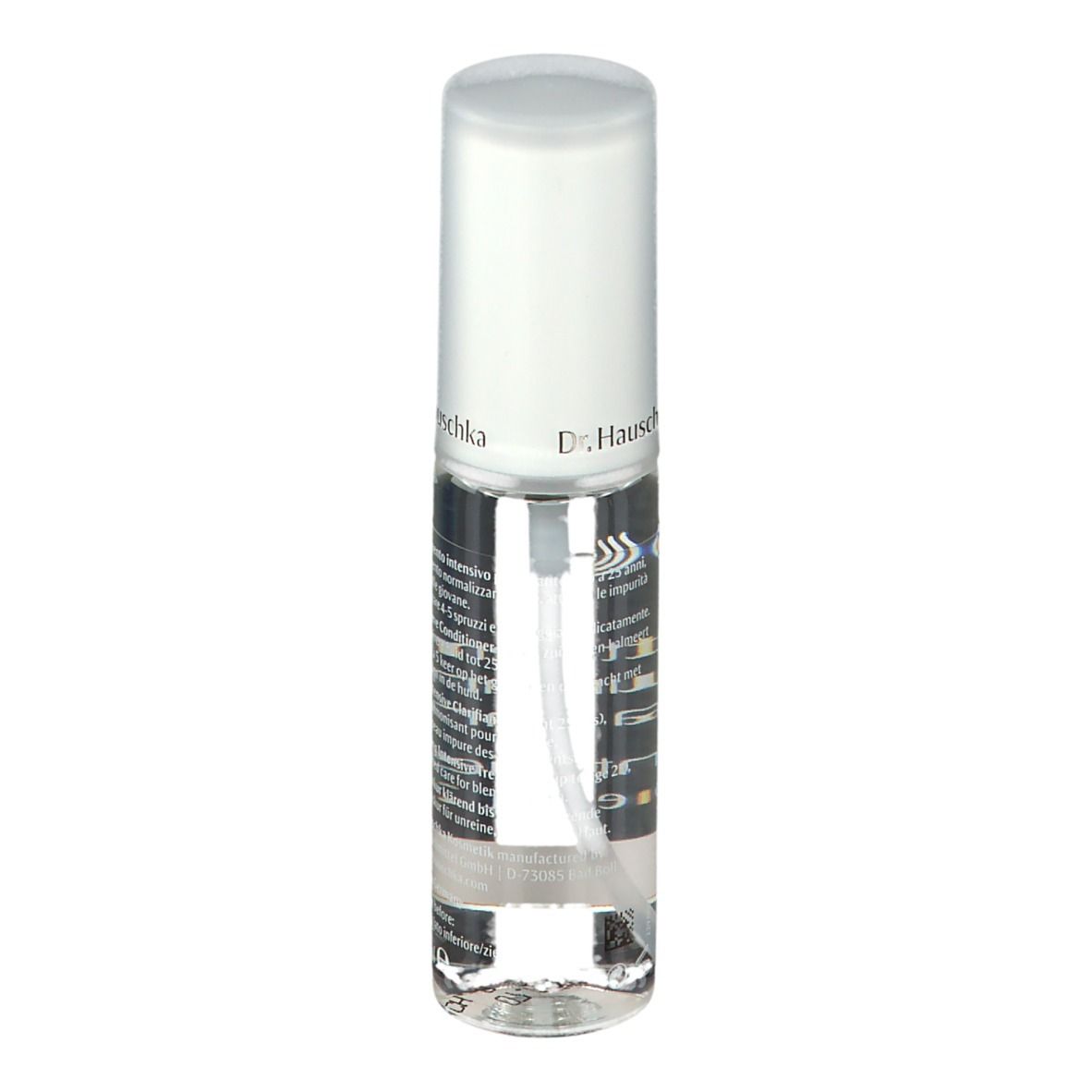 Flacone trasparente con vaporizzatore. Scritta: Dr. Hauschka. Striscia gialla. Etichetta con testo.