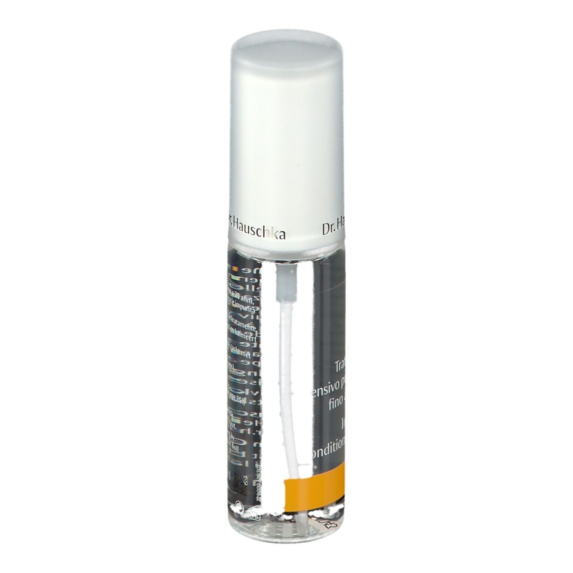 Flacone trasparente con vaporizzatore. Scritta: Dr. Hauschka. Striscia gialla. Etichetta con testo.
