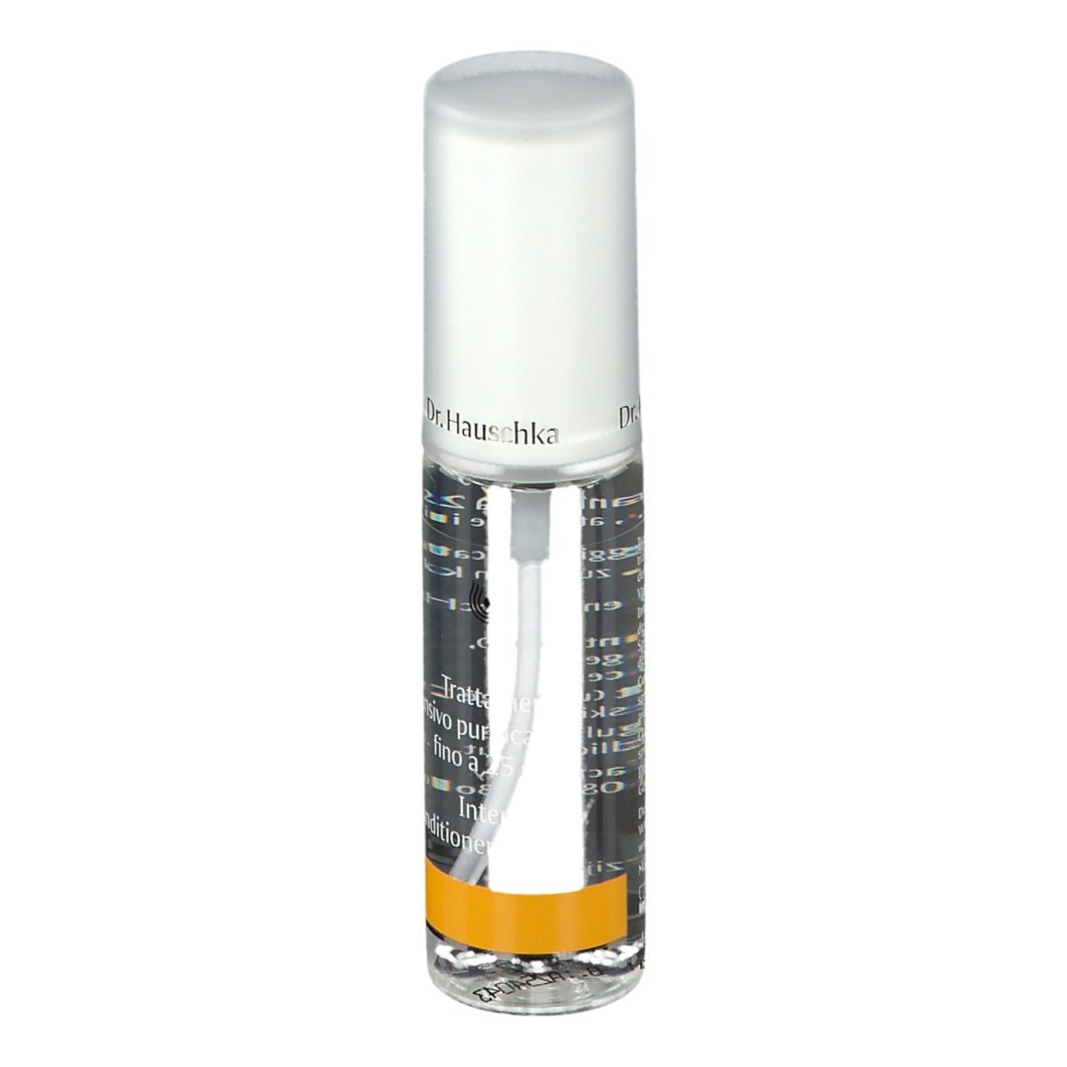 Flacone trasparente con vaporizzatore. Scritta: Dr. Hauschka. Striscia gialla. Etichetta con testo.