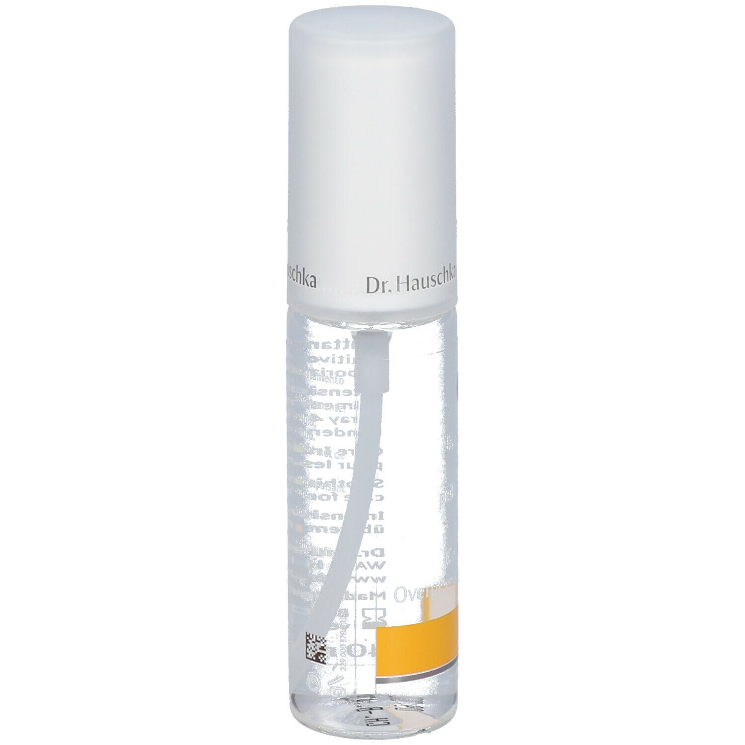 Flacone trasparente con erogatore spray. Scritta: Dr. Hauschka. Etichetta con testo. Striscia gialla in basso.