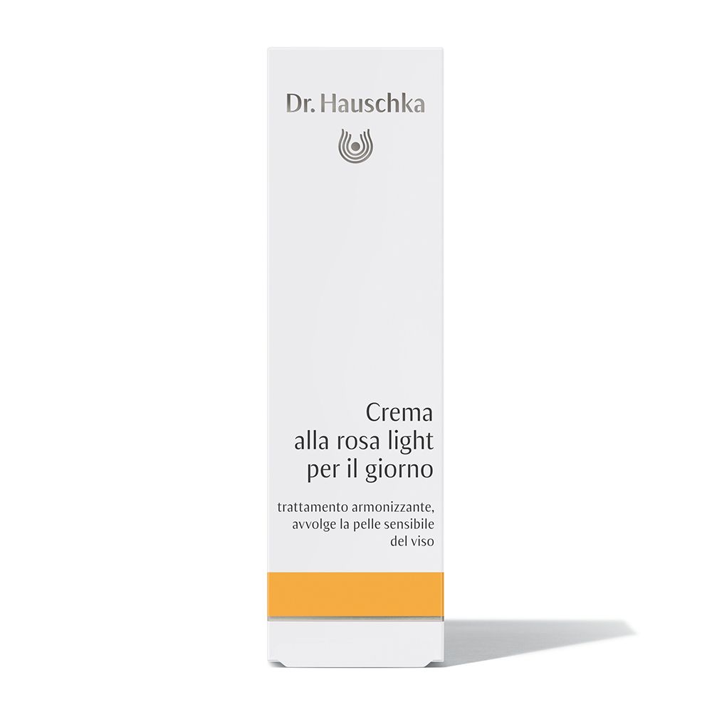 Confezione bianca con fascia gialla. Scritta: Dr. Hauschka, Creme alla rosa light per il giorno, testo.