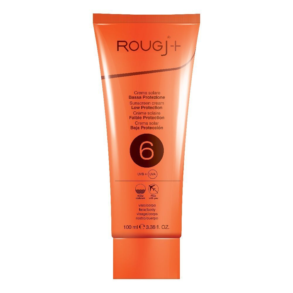 Tube orange de crème solaire. Texte: ROUGJ+, crème solaire SPF 6. Texte multilingue. Logo UVB+UVA. Visage/corps. 100 ml.