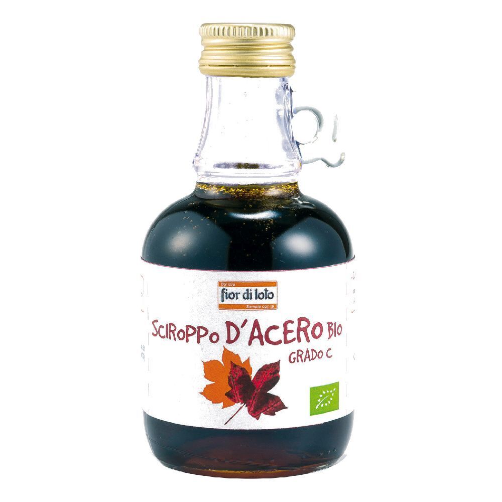 Bottiglia di vetro con sciroppo d'acero. Etichetta con testo e foglia d'acero. Tappo dorato. Manico.