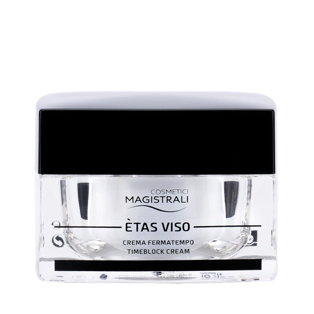 Vasetto di crema con coperchio nero. Scritta: COSMETICI MAGISTRALI, ÈTAS VISO, CREMA FERMATEMPO, TIMEBLOCK CREAM.