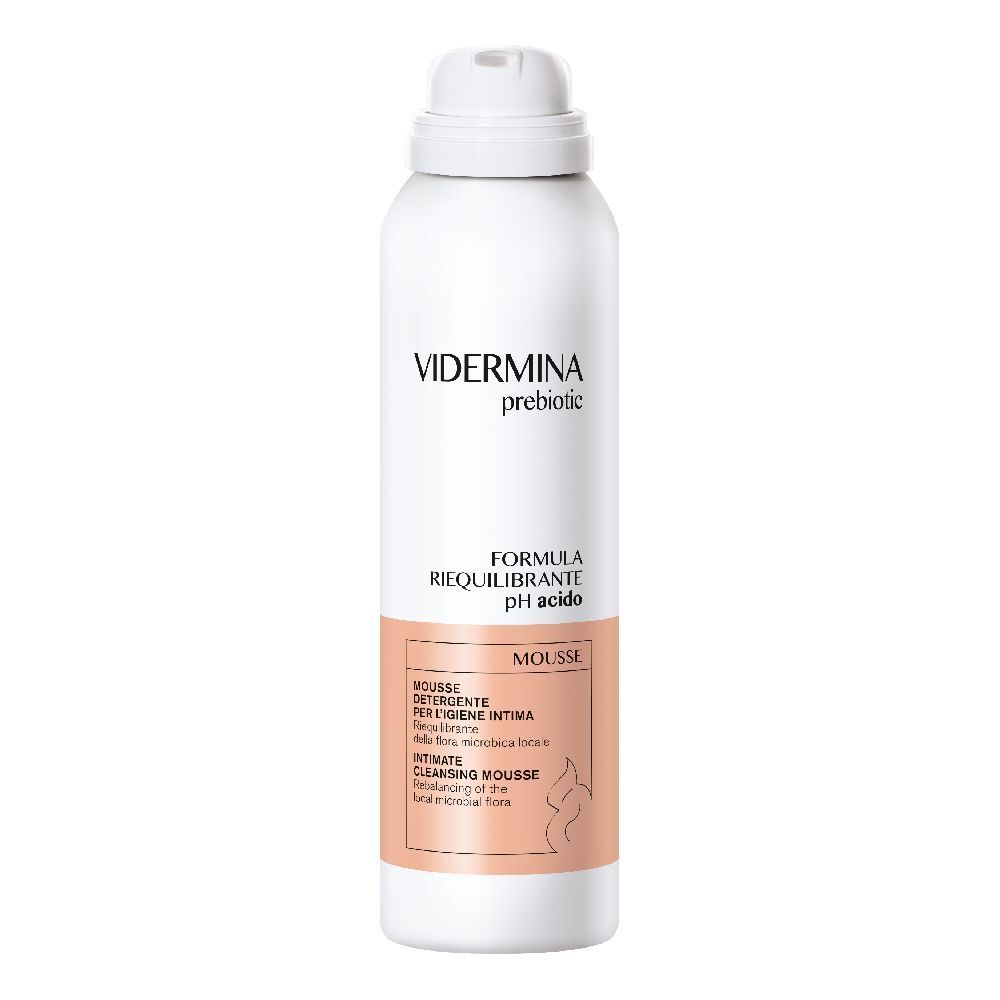 Flacone bianco con erogatore spray. Scritta: Vidermina prebiotic, Formula riequilibrante pH acido. Etichetta rosa con testo.