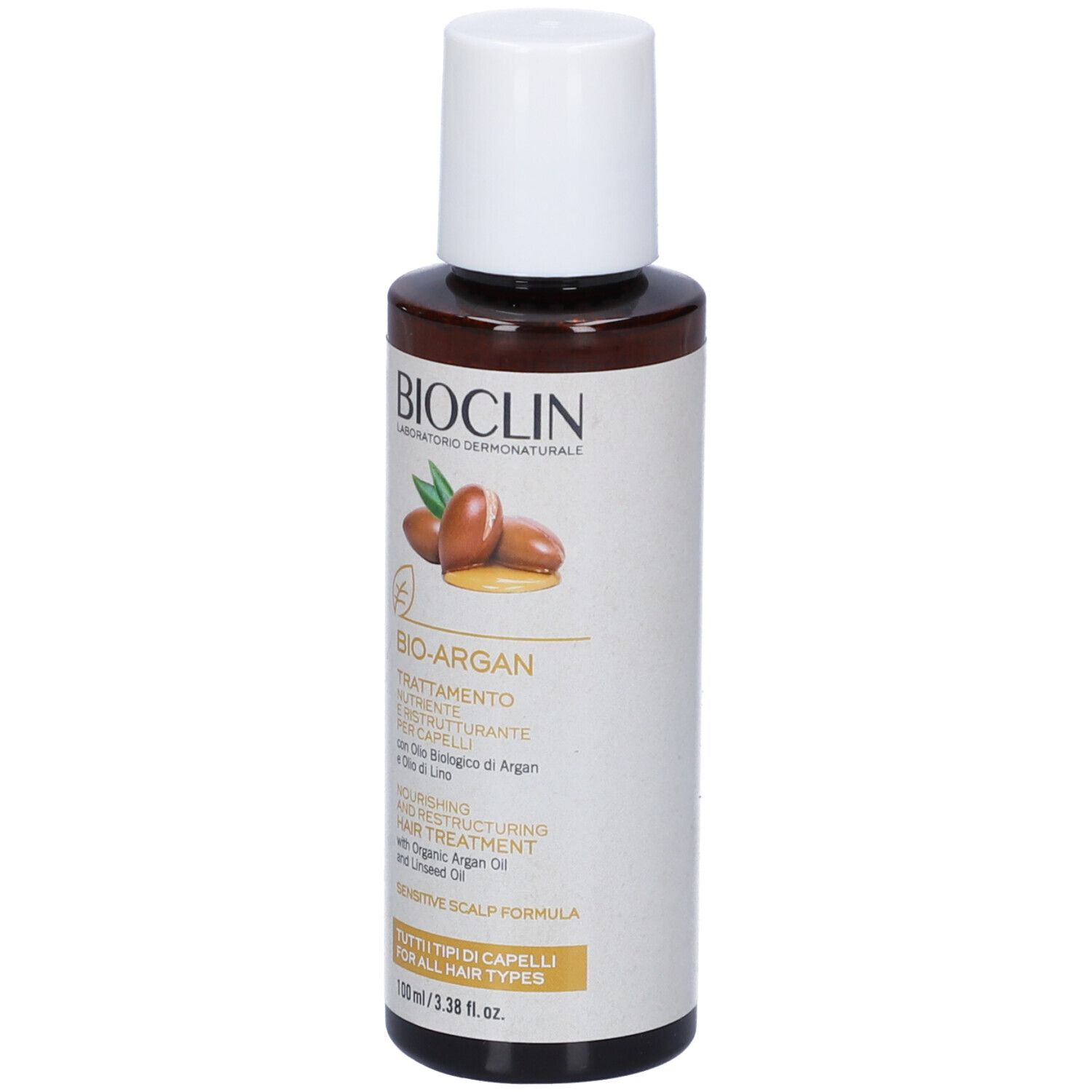 Flacone marrone con tappo bianco. Scritta: BIOCLIN, BIO-ARGAN, Trattamento, con olio di Argan e lino.