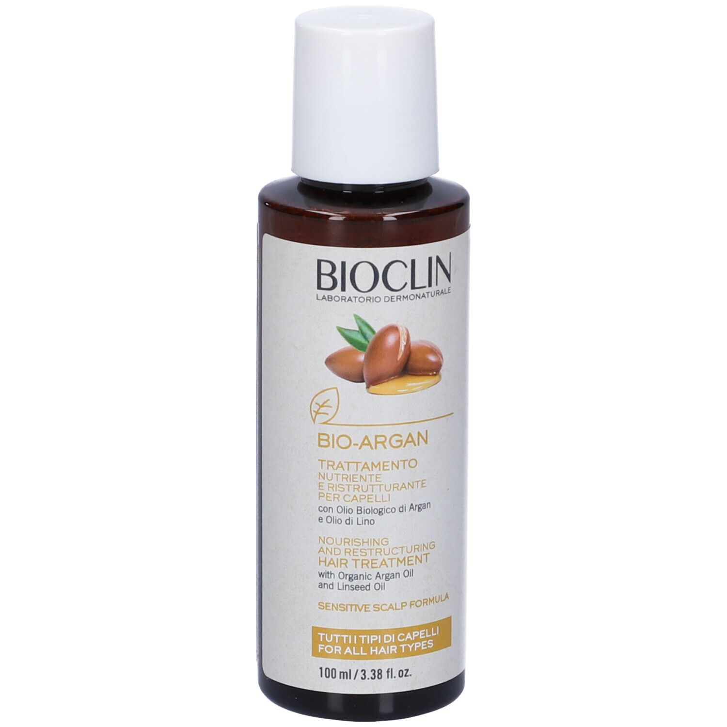 Flacone marrone con tappo bianco. Scritta: BIOCLIN, BIO-ARGAN, Trattamento, con olio di Argan e lino.