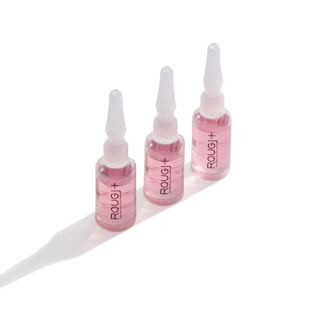 Drei Glasampullen mit rosa Flüssigkeit und dem Aufdruck ROUGJ+.