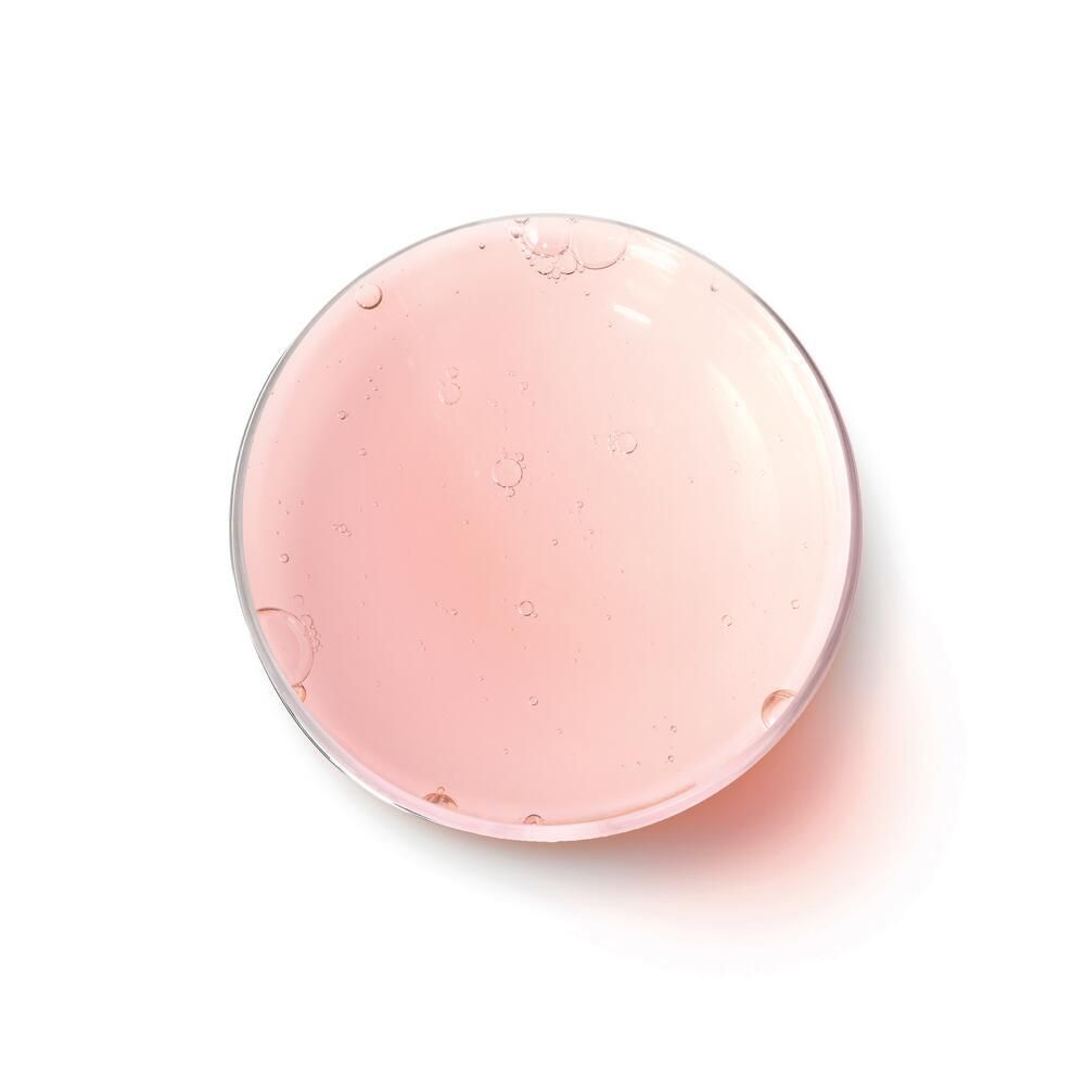 Runder, transparenter Behälter mit rosa Flüssigkeit. Oben betrachtet.