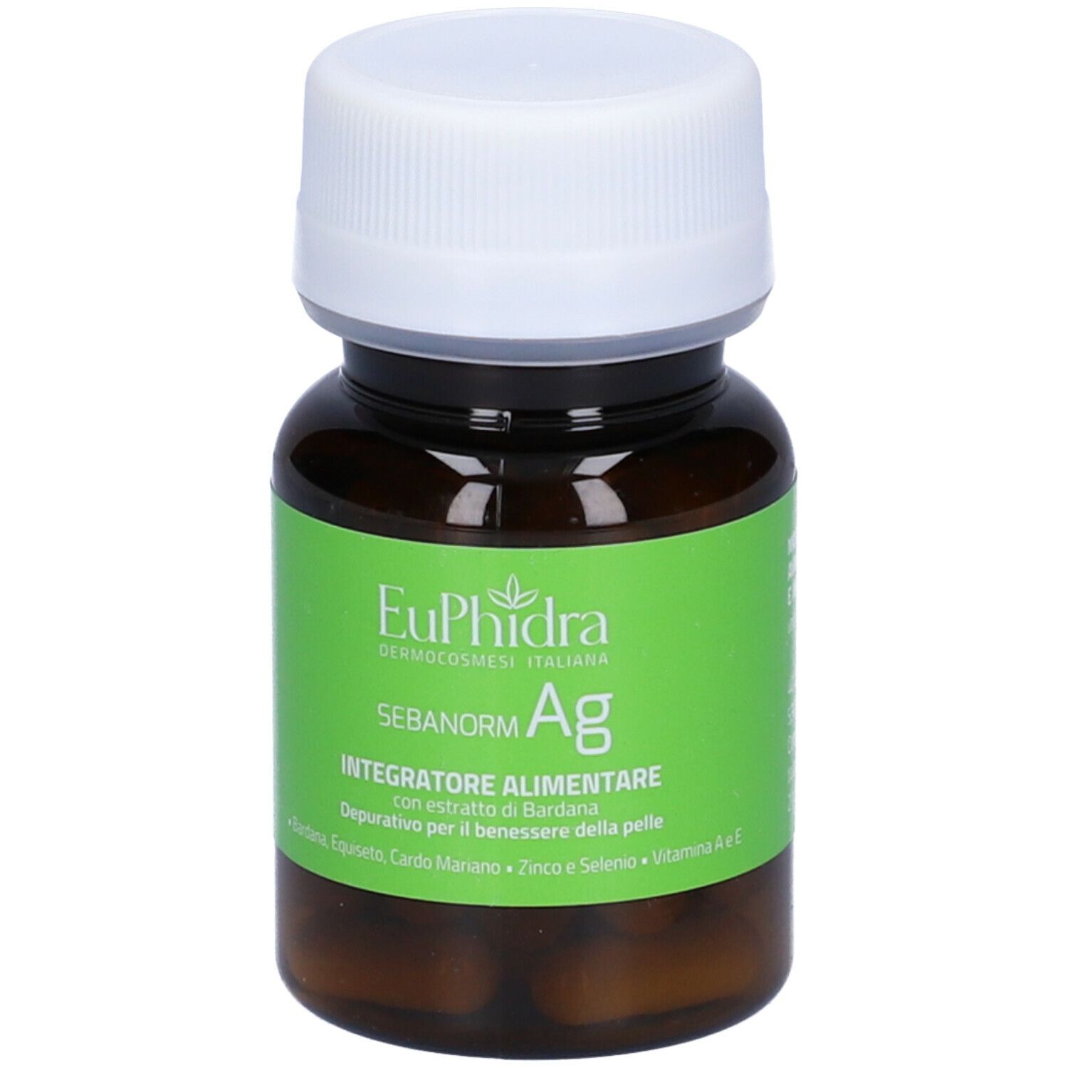 Flacone marrone con tappo bianco. Etichetta verde con nome prodotto e ingredienti. Capsule visibili.
