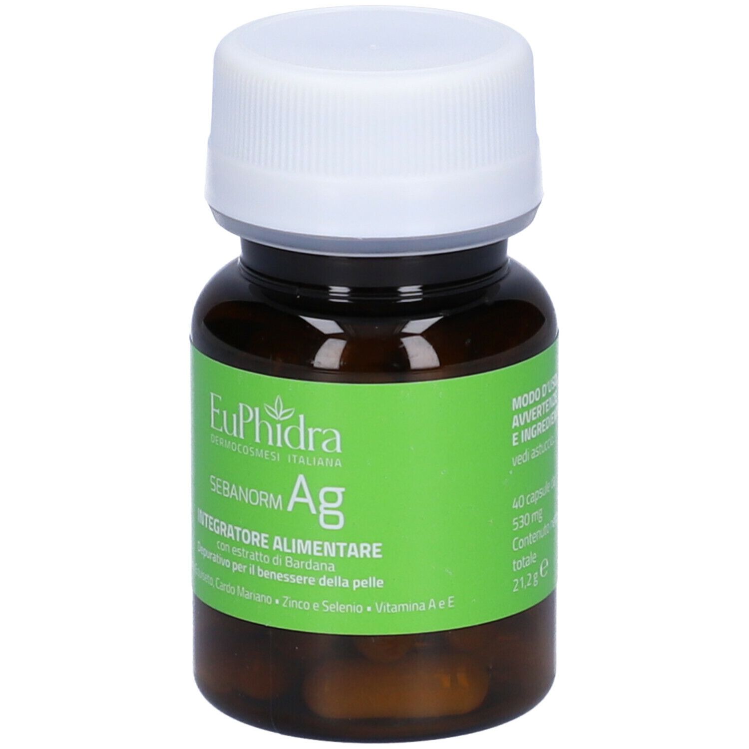 Flacone marrone con tappo bianco. Etichetta verde con nome prodotto e ingredienti. Capsule visibili.