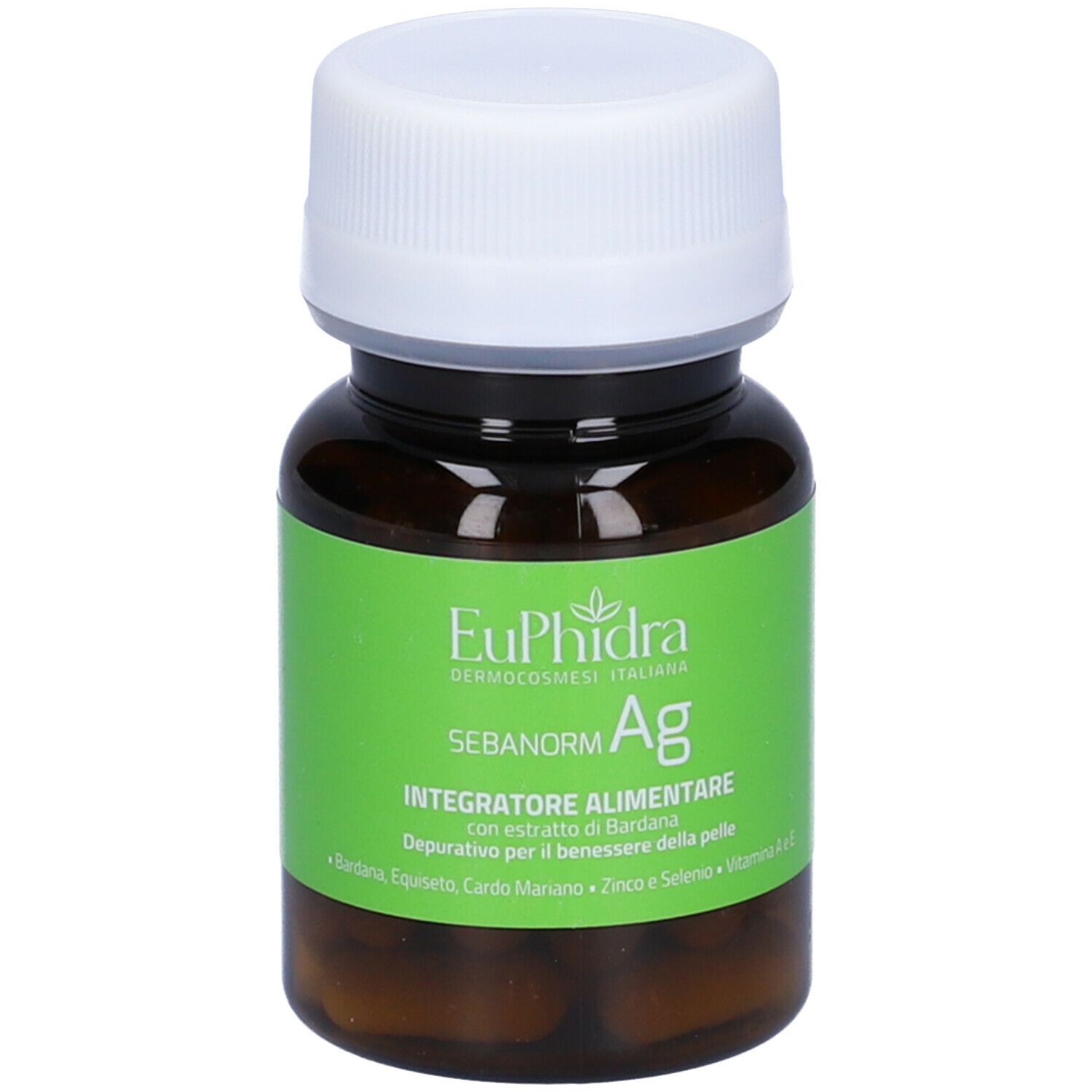 Flacone marrone con tappo bianco. Etichetta verde con nome prodotto e ingredienti. Capsule visibili.