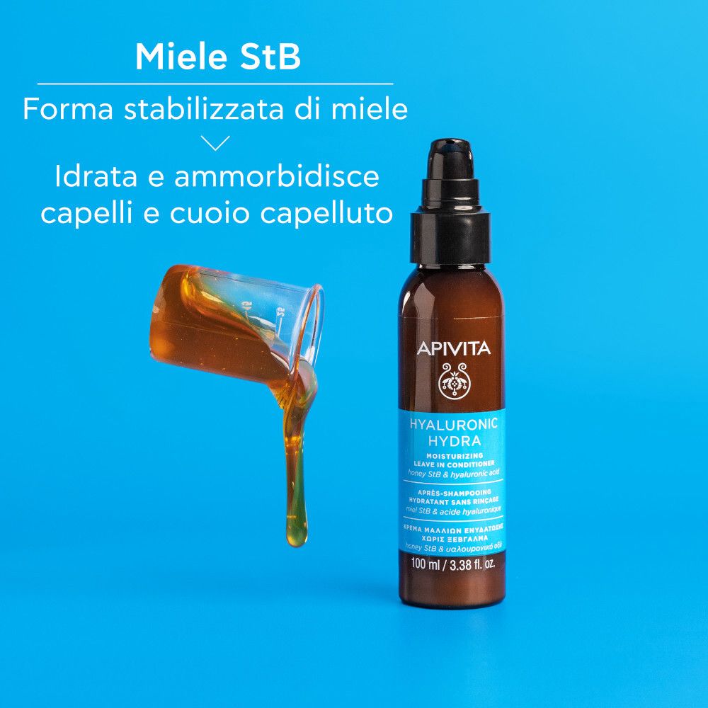 Flacone marrone con erogatore nero. Scritta: Apivita Hyaluronic Hydra. Testo su sfondo blu. Miele versato.