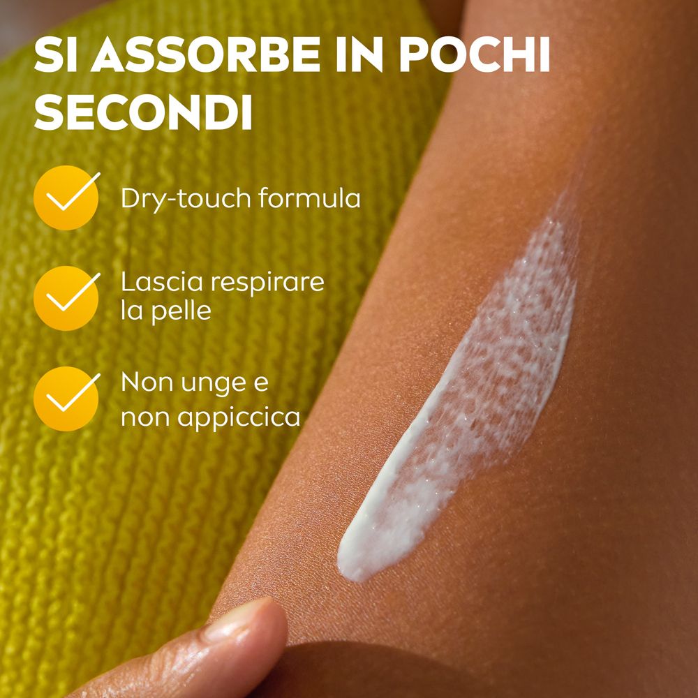 Braccio con crema applicata. Testo: Si assorbe in pochi secondi, formula dry-touch, lascia respirare la pelle, non unge.