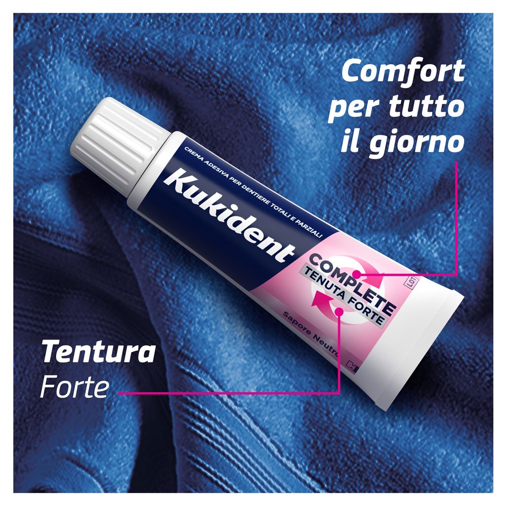 Zahncreme-Tube auf blauem Stoff. Aufschrift: Kukident Complete, Tenuta Forte. Text: Tenuta Forte, Comfort.