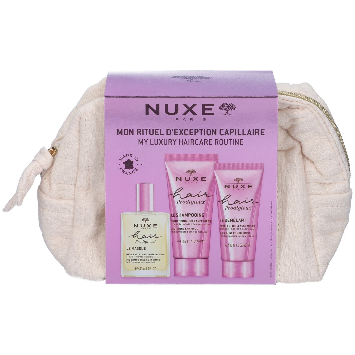 Beauty case con tre prodotti per capelli. Flacone e tubi rosa. Testo: Nuxe Paris. Made in France.