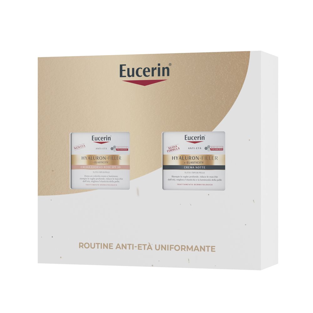 Cofanetto regalo Eucerin. Due creme. Logo Eucerin in alto. Scritta: Routine Anti-Età Uniformante. Confezione bianca e oro.