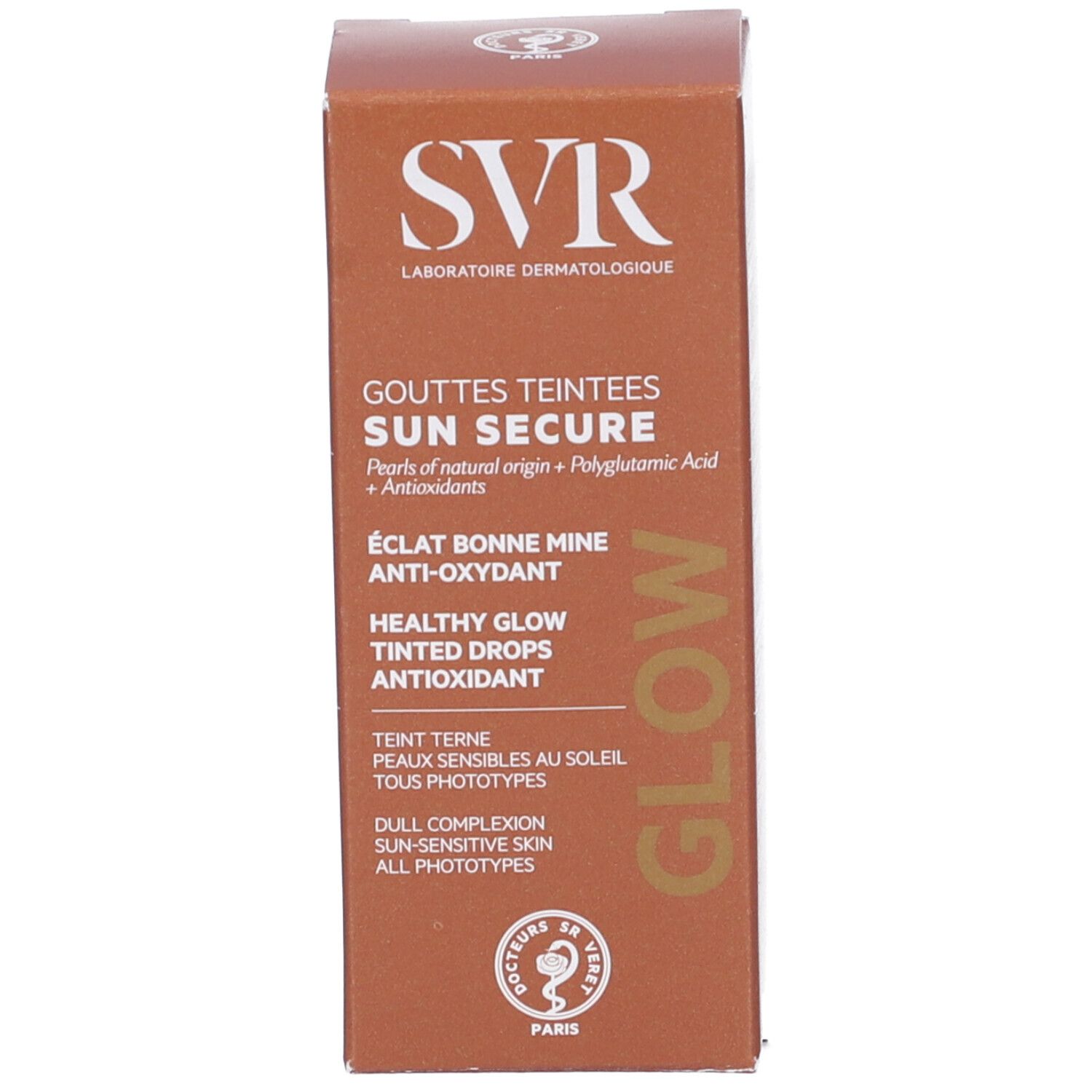 Braune Schachtel. Aufschrift: SVR, SUN SECURE, GOUTTES TEINTEES, GLOW. Text: ÉCLAT BONNE MINE, ANTI-OXYDANT, HEALTHY GLOW, TINTED DROPS, TEINT TERNE.
