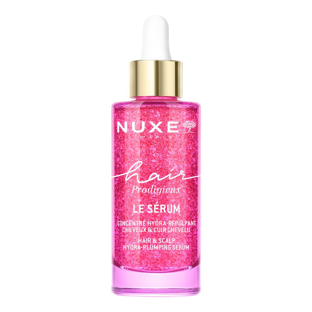 Flacone di siero per capelli Nuxe rosa glitterato con contagocce. Testo: 'NUXE hair Prodigieux LE SÉRUM'.