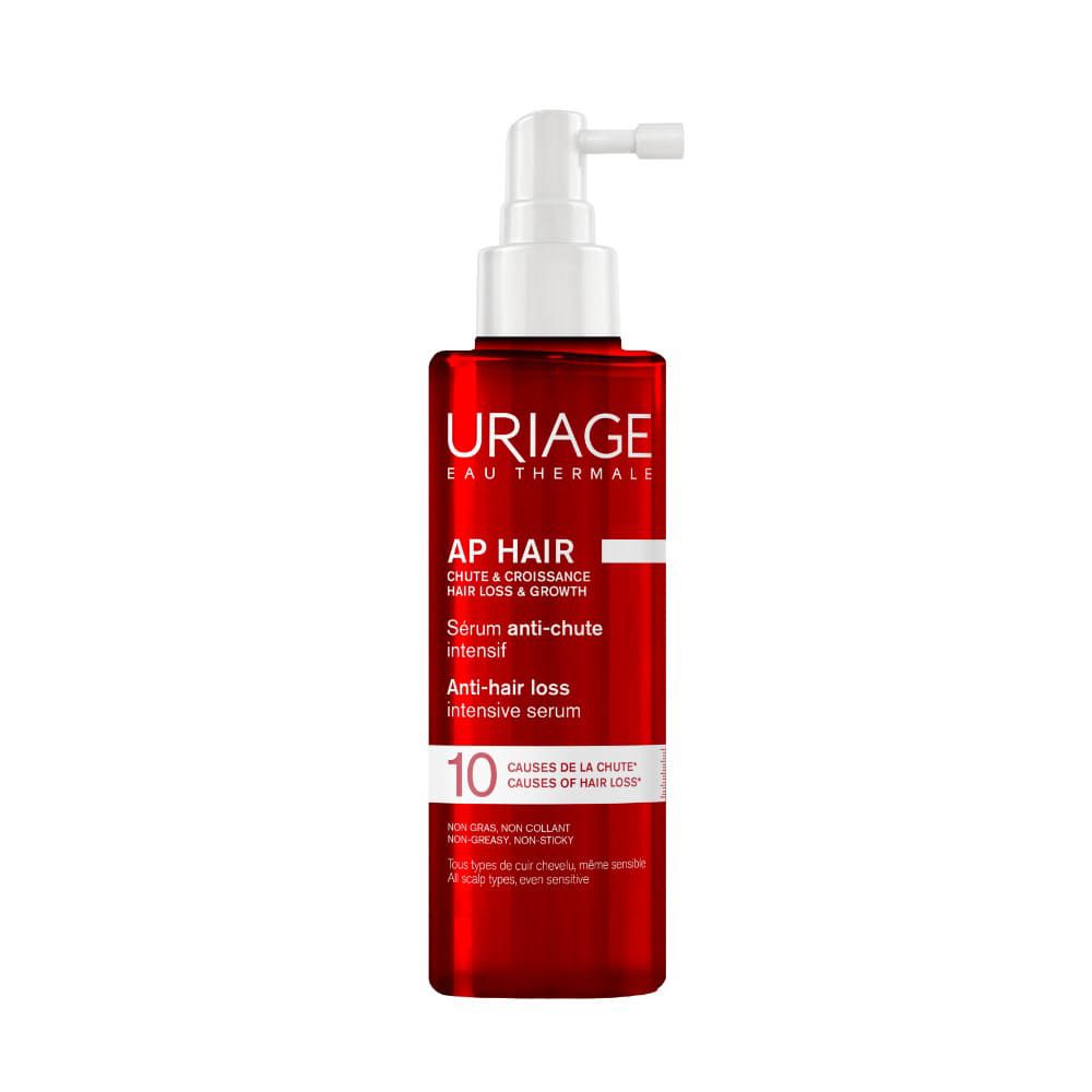 Rote Flasche mit weißem Pumpspender, Uriage AP Hair Serum gegen Haarausfall.