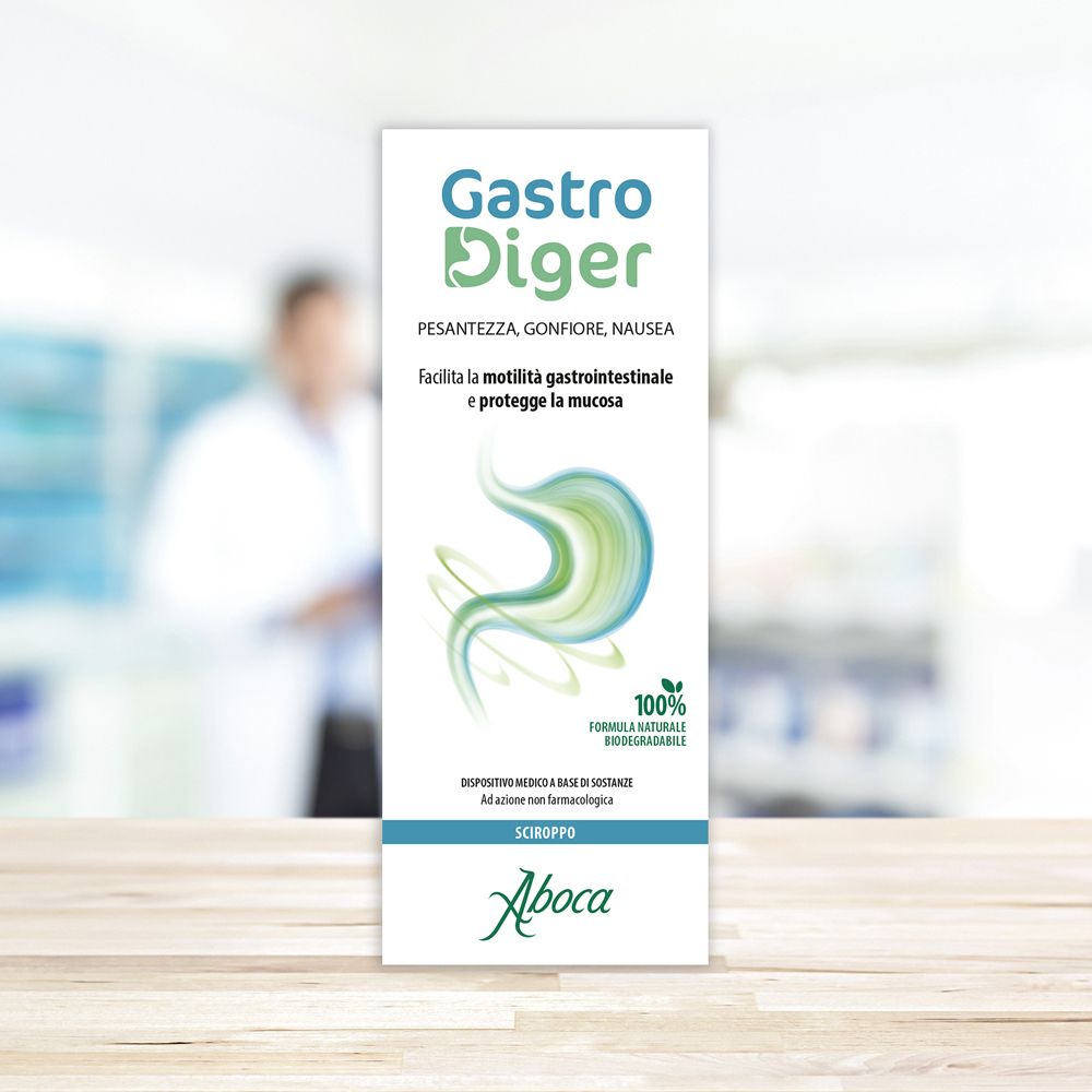 Scatola bianca con logo GastroDiger e informazioni sul prodotto. Logo Aboca in basso. Sfondo sfocato.