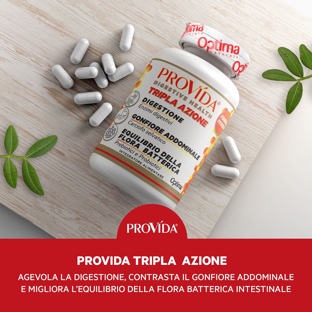 Provida® Dreifachwirkung Dose mit verstreuten Kapseln auf Holzunterlage, mit grünen Blättern.