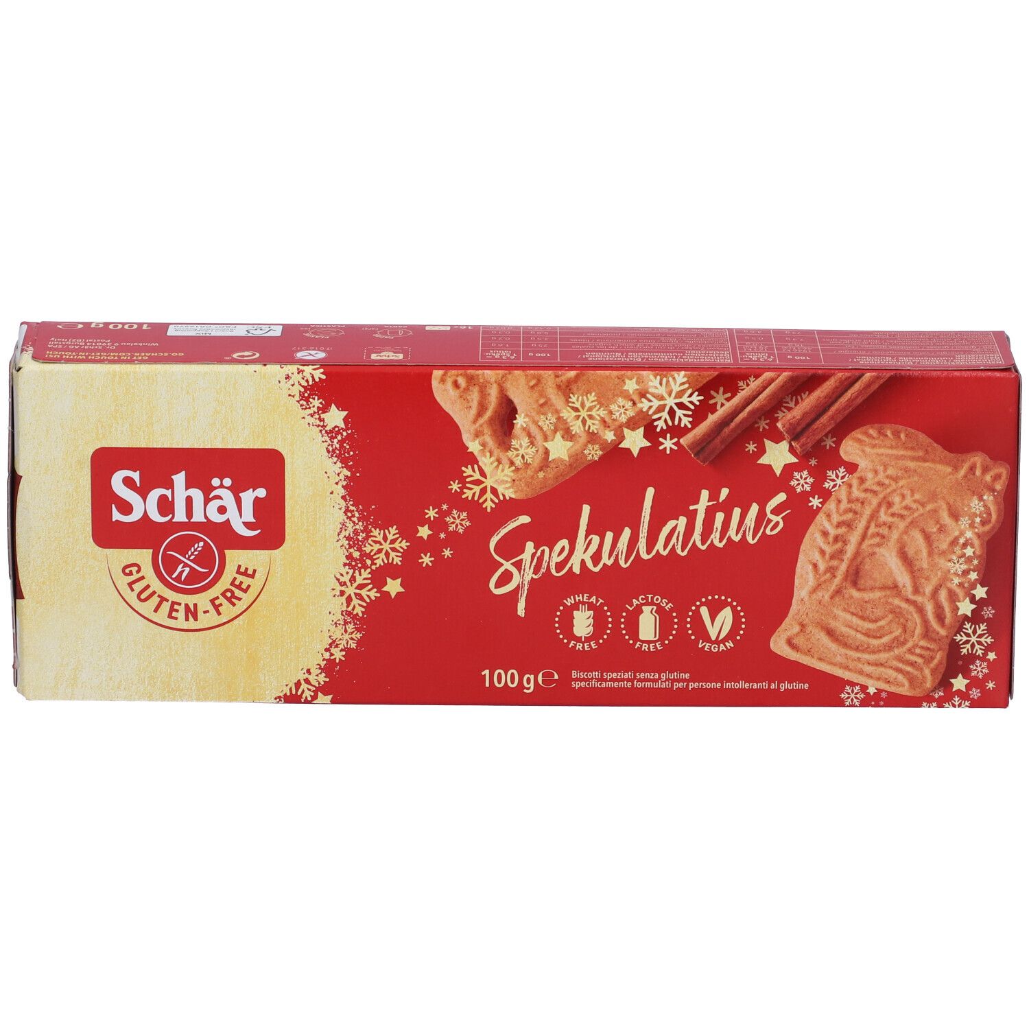 Scatola di Spekulatius senza glutine. Scritte "Schär", "Spekulatius", "senza glutine" e loghi. Bastoncini di cannella e biscotti.