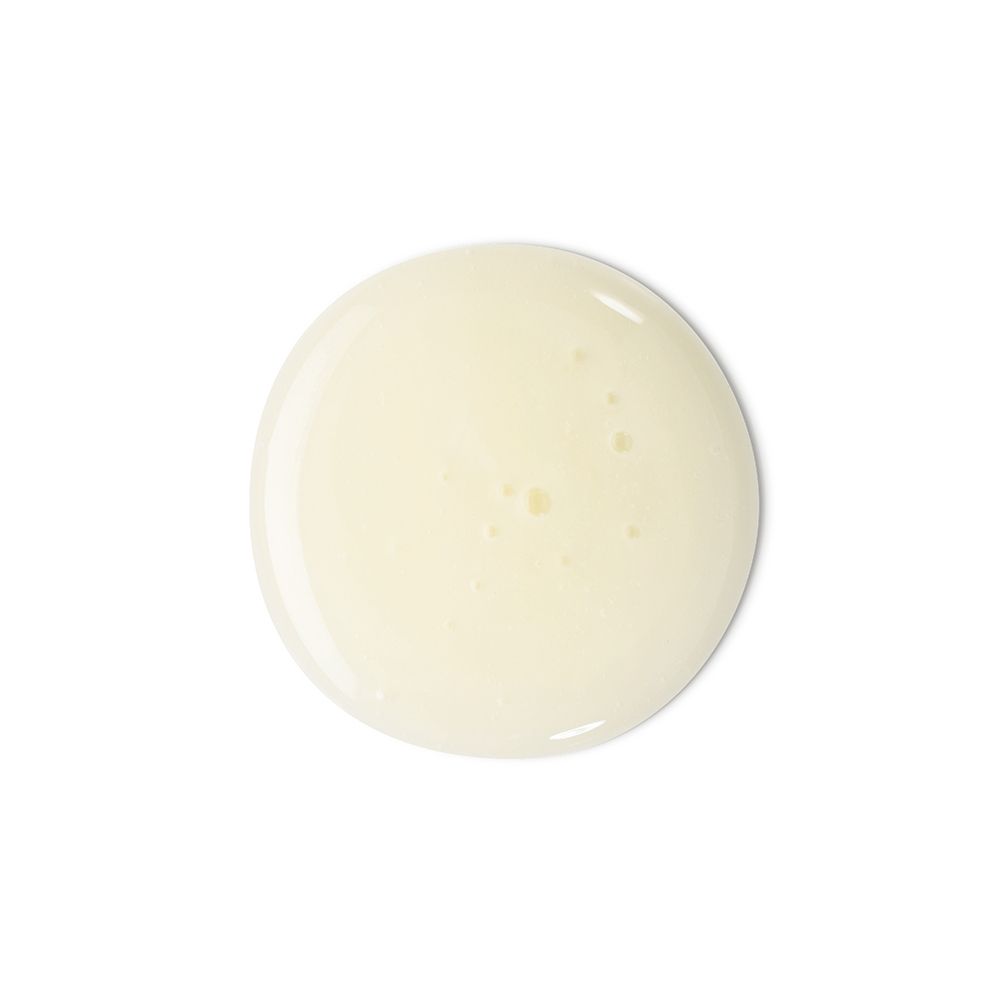 Liquido giallo su sfondo bianco. Probabilmente shampoo. Forma rotonda.
