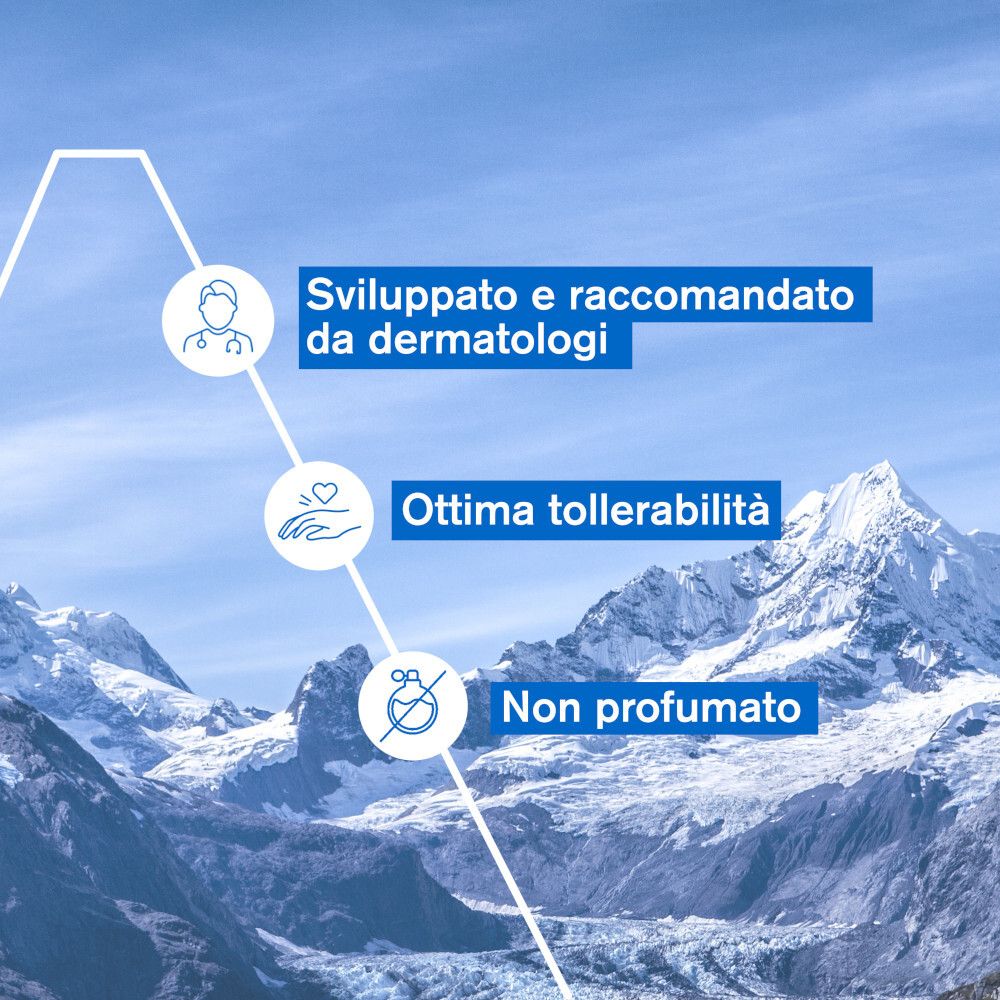 Testo: Sviluppato e raccomandato da dermatologi, Ottima tollerabilità, Non profumato. Sfondo: Montagne.