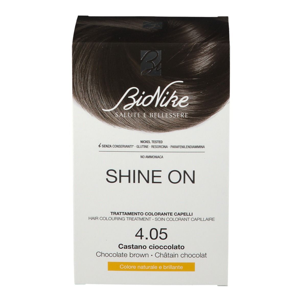 BioNike Shine On colorazione capelli 4.05 Cioccolato marrone. Confezione bianca con nome e tonalità del prodotto. Contiene testo in tedesco, italiano, olandese e francese.