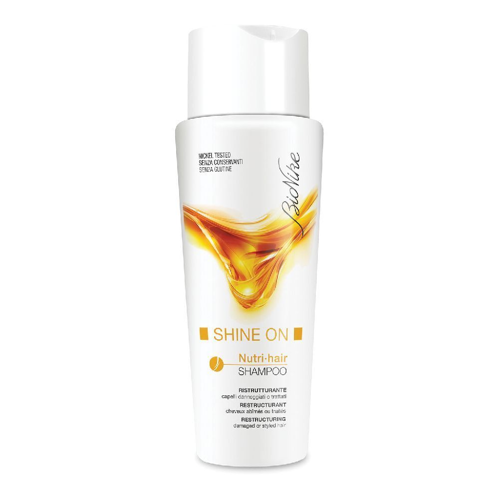Flacon blanc avec design jaune. Inscription: Shine On Nutri-hair Shampoo. Marque: BioNike. Nickel Tested.