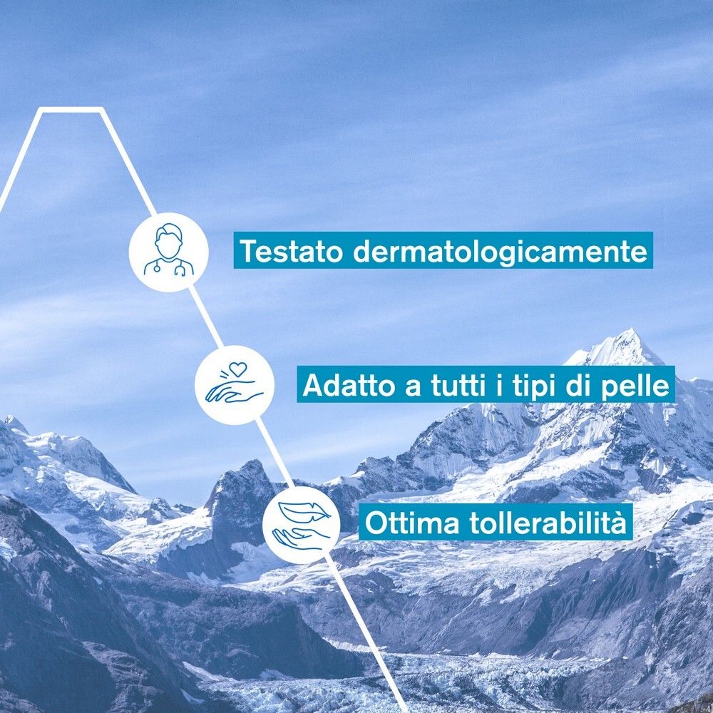 Grafica con testo: Testato dermatologicamente, Adatto a tutti i tipi di pelle, Ottima tollerabilità. Sfondo: montagne.