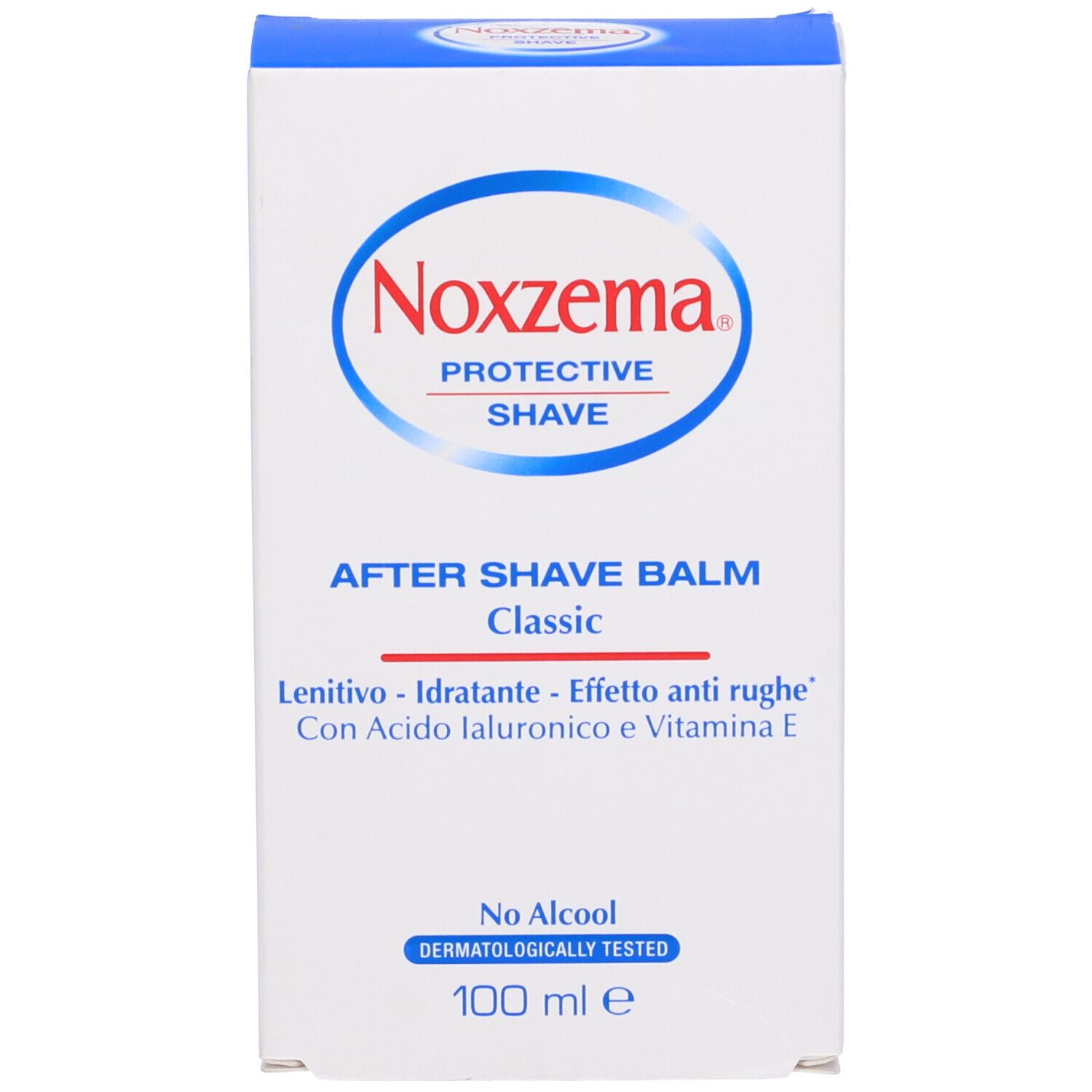 Scatola bianca. Scritta: Noxzema After Shave Balm Classic. Dettagli blu. Dermatologicamente testato.