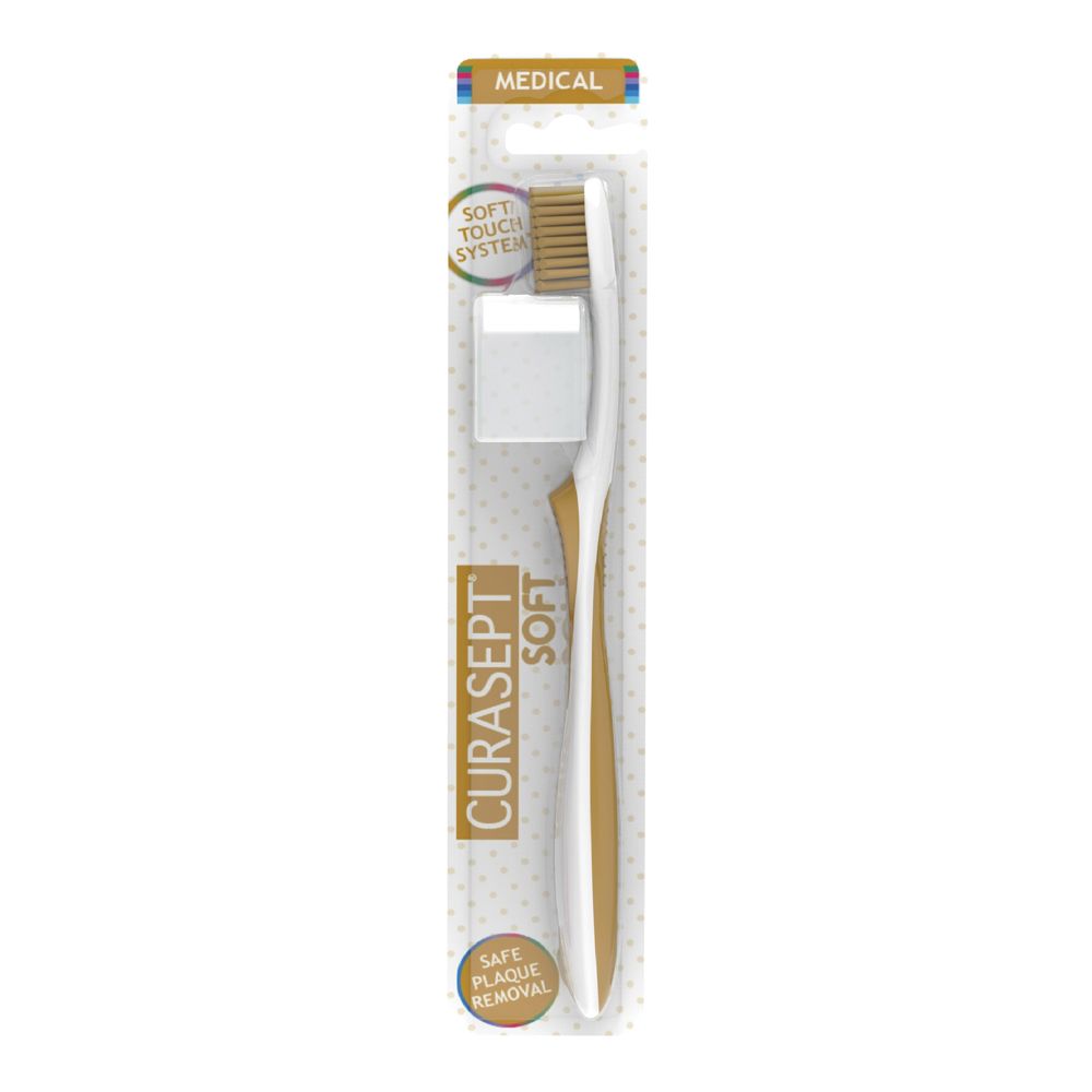 Spazzolino bianco e oro. Confezione con nome del prodotto e scritta "Soft Touch System".