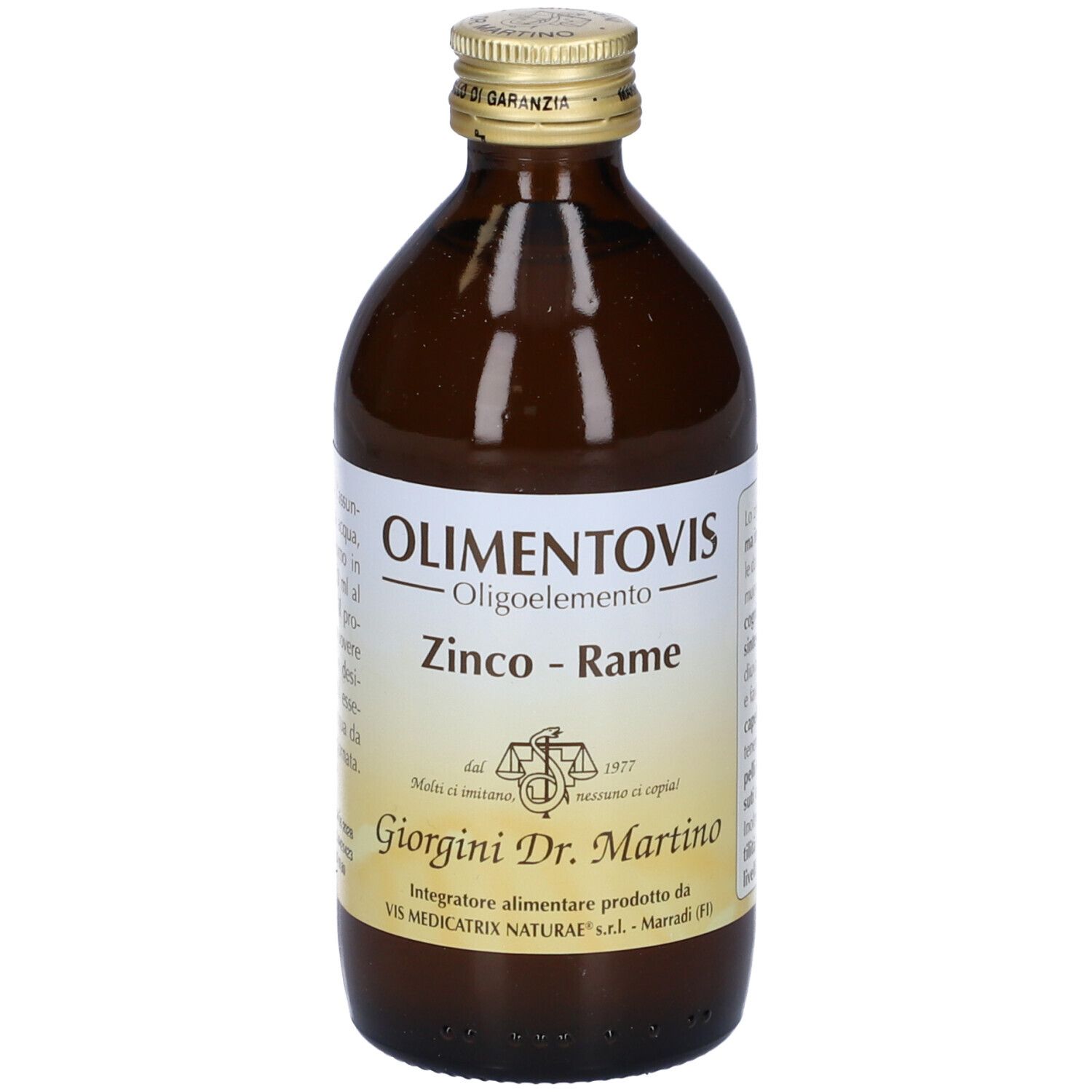 Bottiglia di vetro marrone con tappo dorato. Scritto: Olimentovis, Zink-Rame. Etichetta con testo.