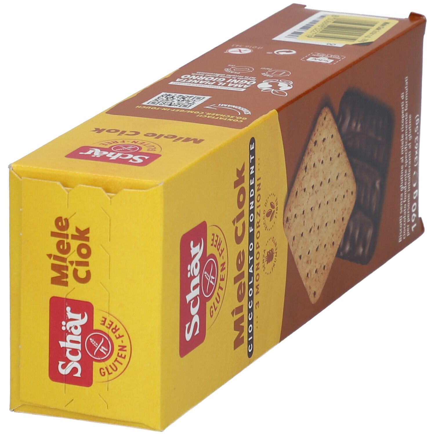 Scatola di biscotti Miele Ciok. La confezione mostra due biscotti, uno ricoperto di cioccolato, in una vista obliqua.