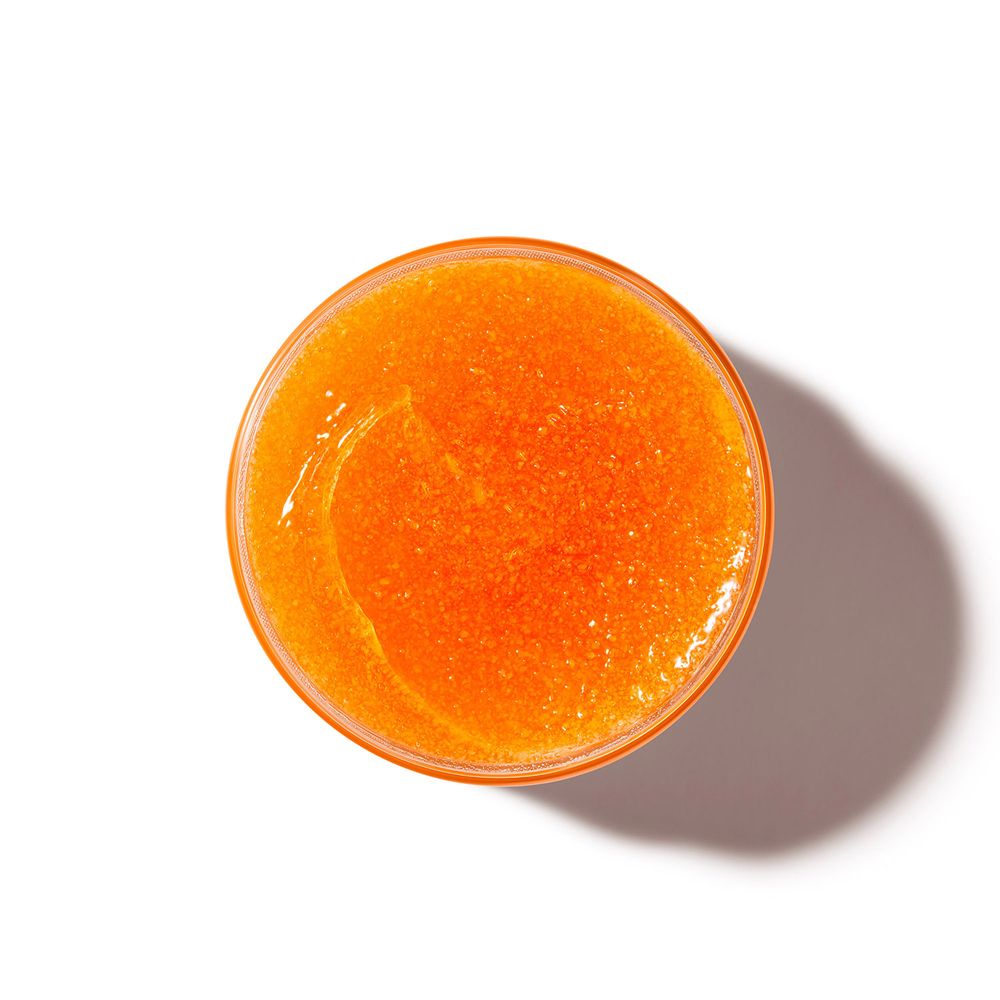 NUXE Rêve de Miel® Scrub Corpo. Vista dall'alto dello scrub arancione nel vasetto.