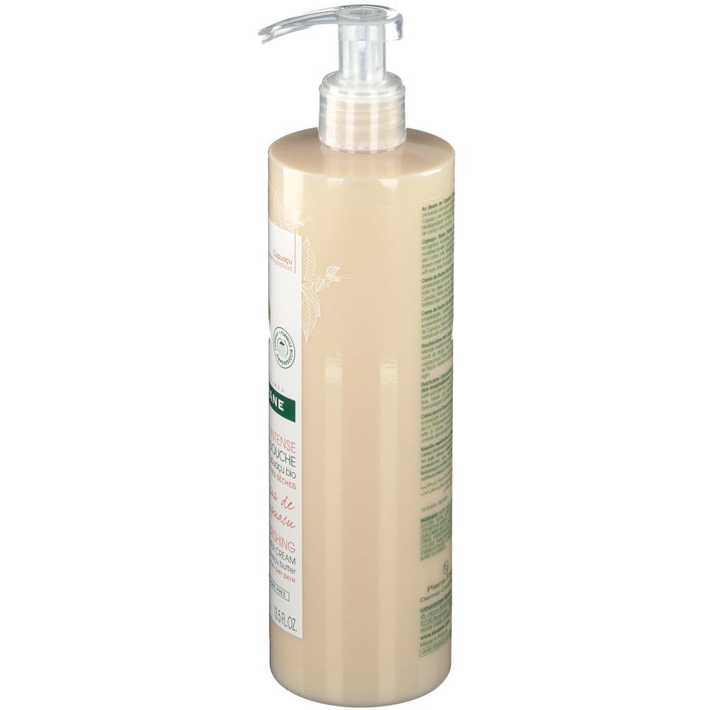 Klorane Duschcreme, Seitenansicht. Flasche mit Pumpe. Beige Flüssigkeit. Etikett mit Produktinformationen.