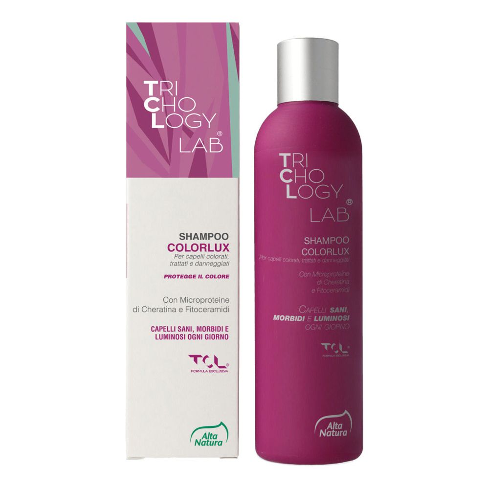 Flacone e scatola di shampoo Colorlux. Flacone viola con tappo argentato. Scatola con logo e informazioni sul prodotto.