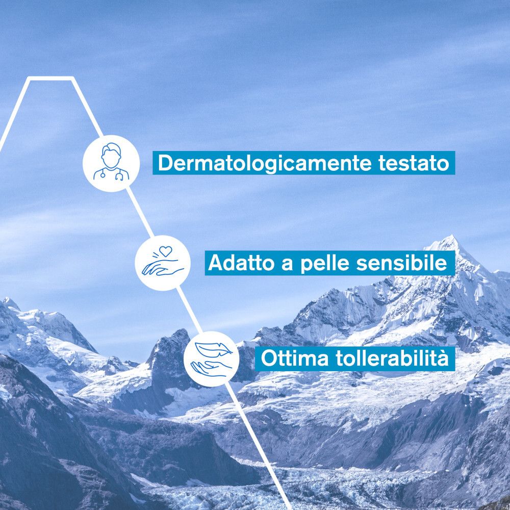 Grafico con informazioni: Dermatologicamente testato, Adatto a pelle sensibile, Ottima tollerabilità. Sfondo: paesaggio montano.