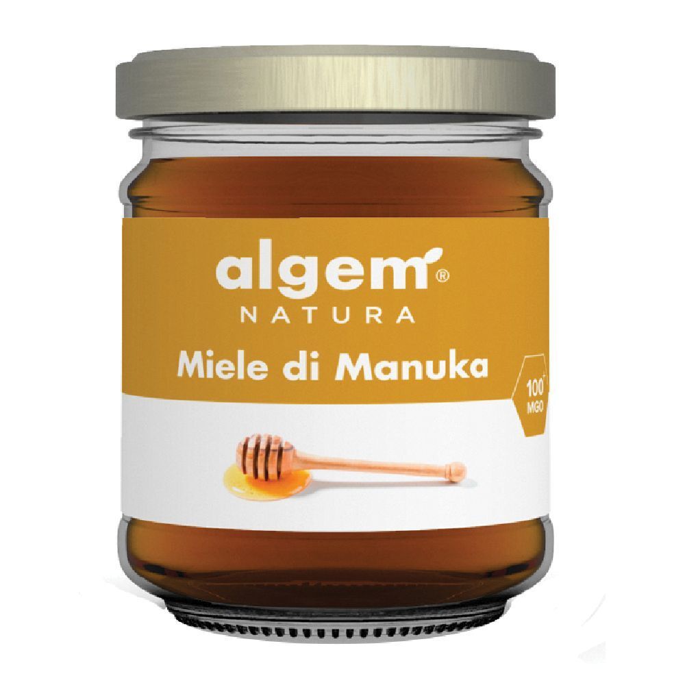 Barattolo di miele "Algem Natura Miele di Manuka". Etichetta con cucchiaino e goccia di miele. Coperchio dorato.