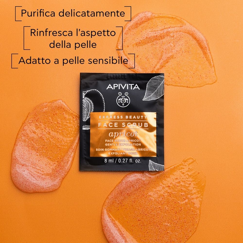 Bustina nera con informazioni sul prodotto e macchie di prodotto arancioni. Scritto: APIVITA EXPRESS BEAUTY FACE SCRUB apricot.
