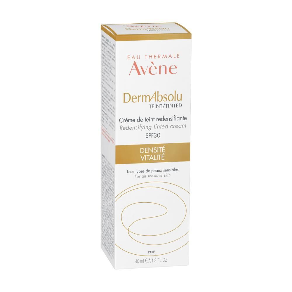Avène DermAbsolu Crème teintée SPF 30 en emballage. Boîte blanche et dorée. Texte: DermAbsolu, teinté, SPF 30. Pour peaux sensibles.