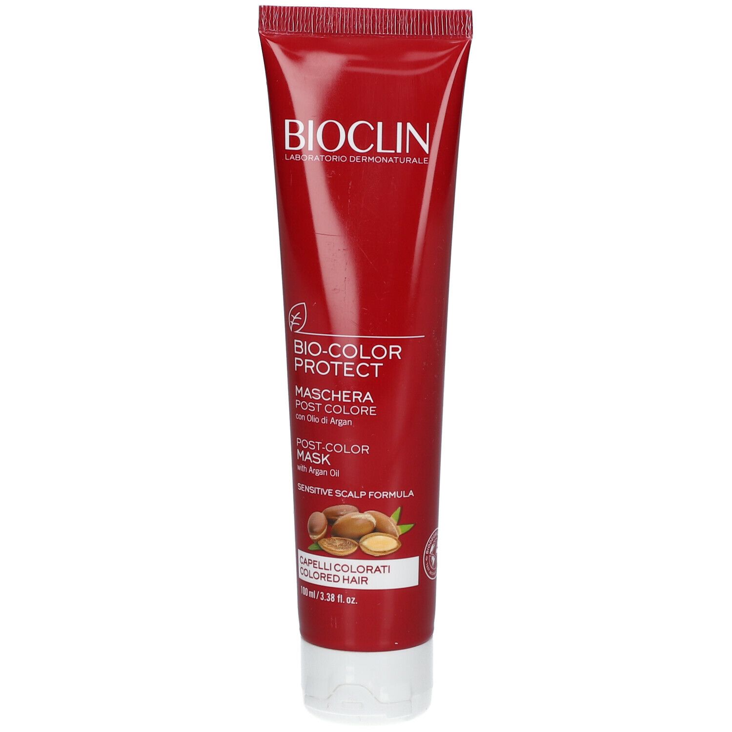Tubo rosso BIOCLIN. Scritta "Bio-Color Protect Maschera Post Colore". Illustrazione semi di olio di Argan. Testo in italiano.