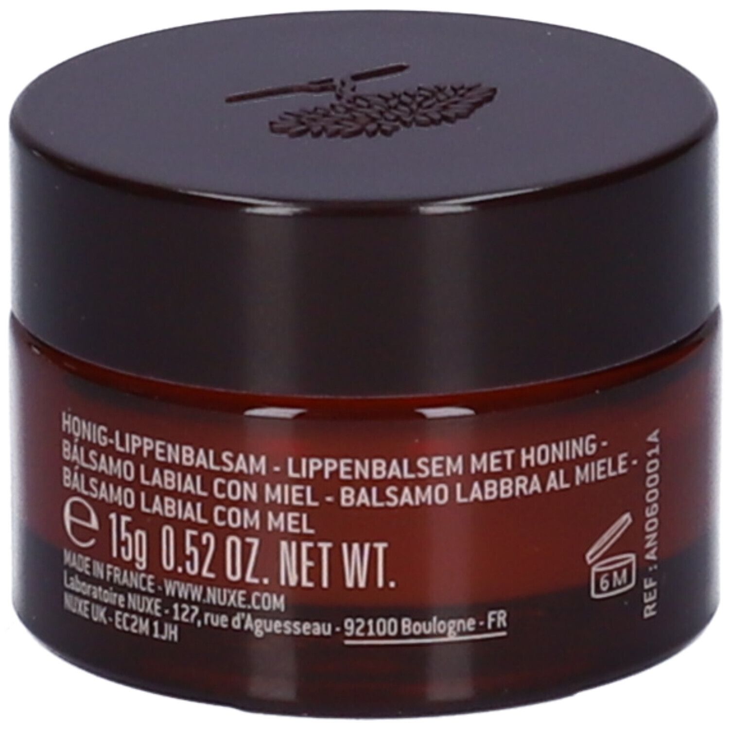 Vasetto marrone con coperchio. Scritta: Balsamo labbra al miele, 15g, 0.52 OZ. NET WT. Sul lato: Riferimento e simbolo 6M.