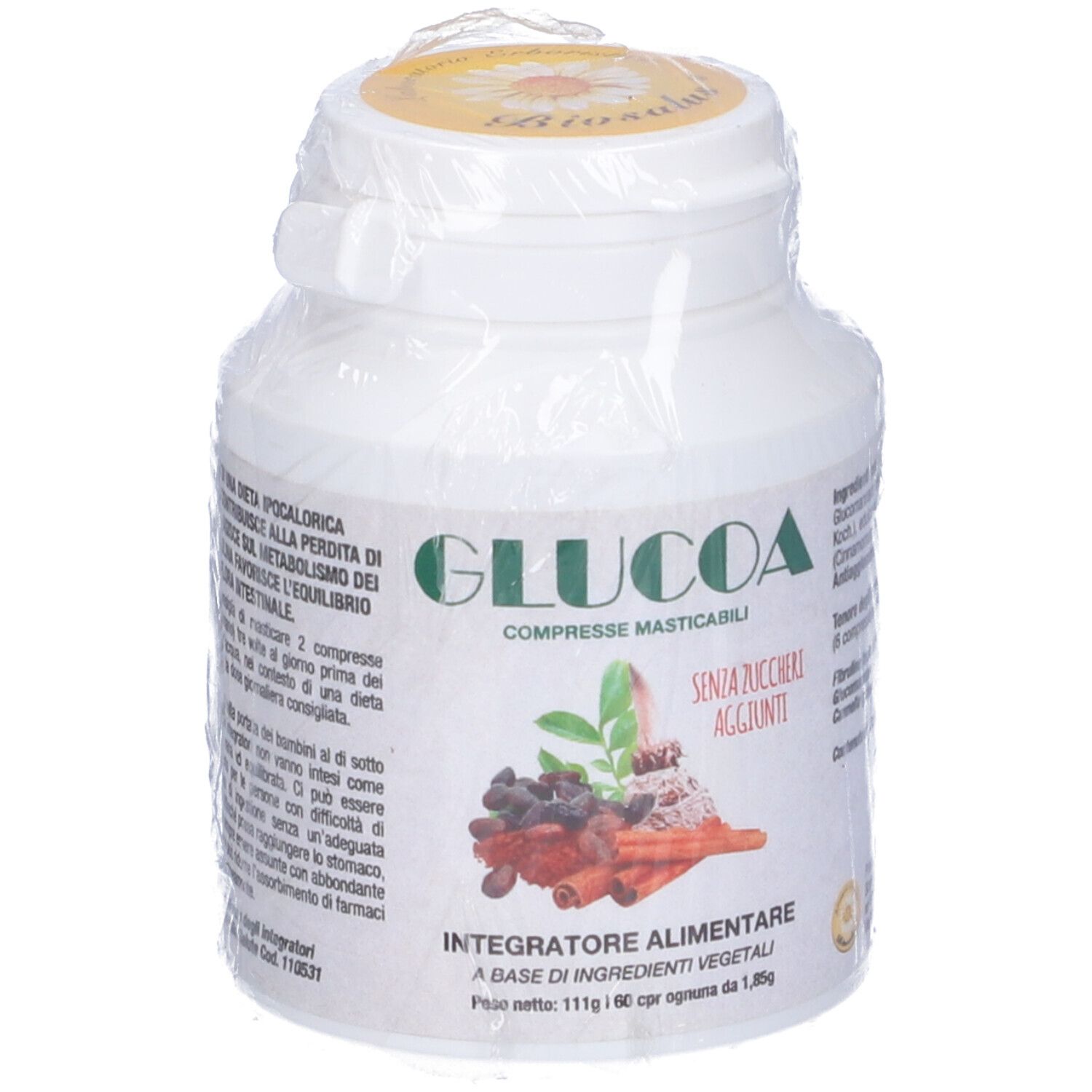 Flacone bianco "GLUCOA" in confezione di plastica. Visibili le scritte "COMPRESSE MASTICABILI" e "SENZA ZUCCHERI AGGIUNTI".